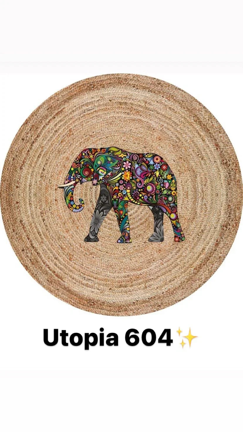 Round natural fiber rug with colorful floral elephant design, model Utopia 604.