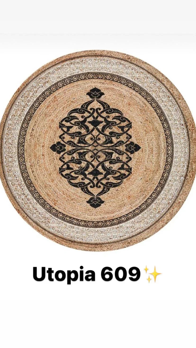 Round woven rug with black ornate central pattern and white decorative border, natural tones