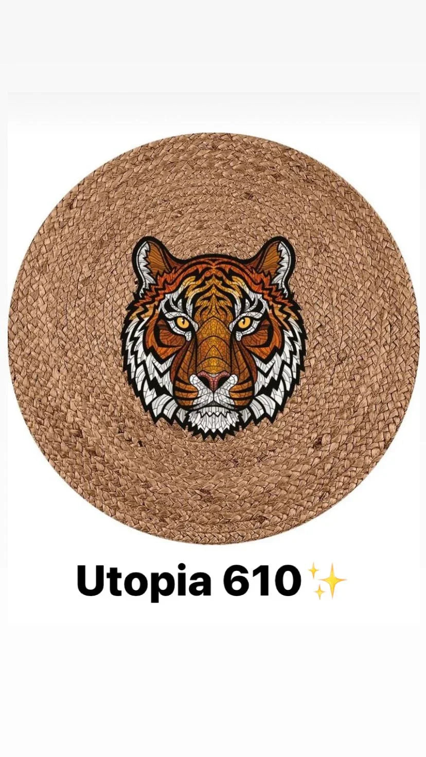 Round braided natural fiber rug with colorful tiger head design in center.