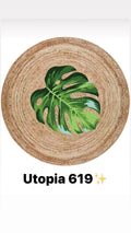 Round natural jute rug with green monstera leaf design in the center, Utopia 619 style.