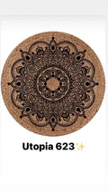 Round woven bamboo rug with intricate black mandala pattern, natural decor accent.