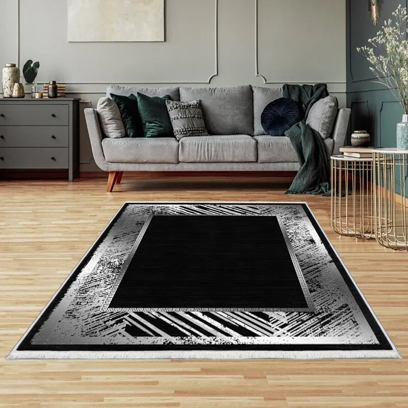 Modern black and grey washable area rug in a stylish living room with wooden floor