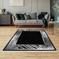 Modern black and grey washable area rug in a stylish living room with wooden floor
